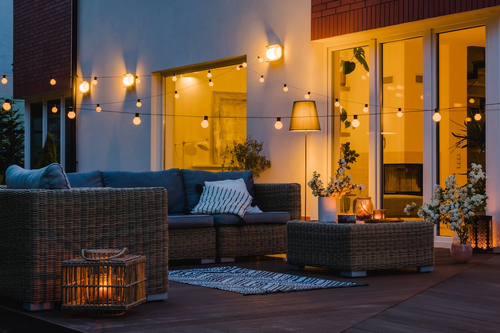 Assortment of outdoor lighting on a patio with furniture.
