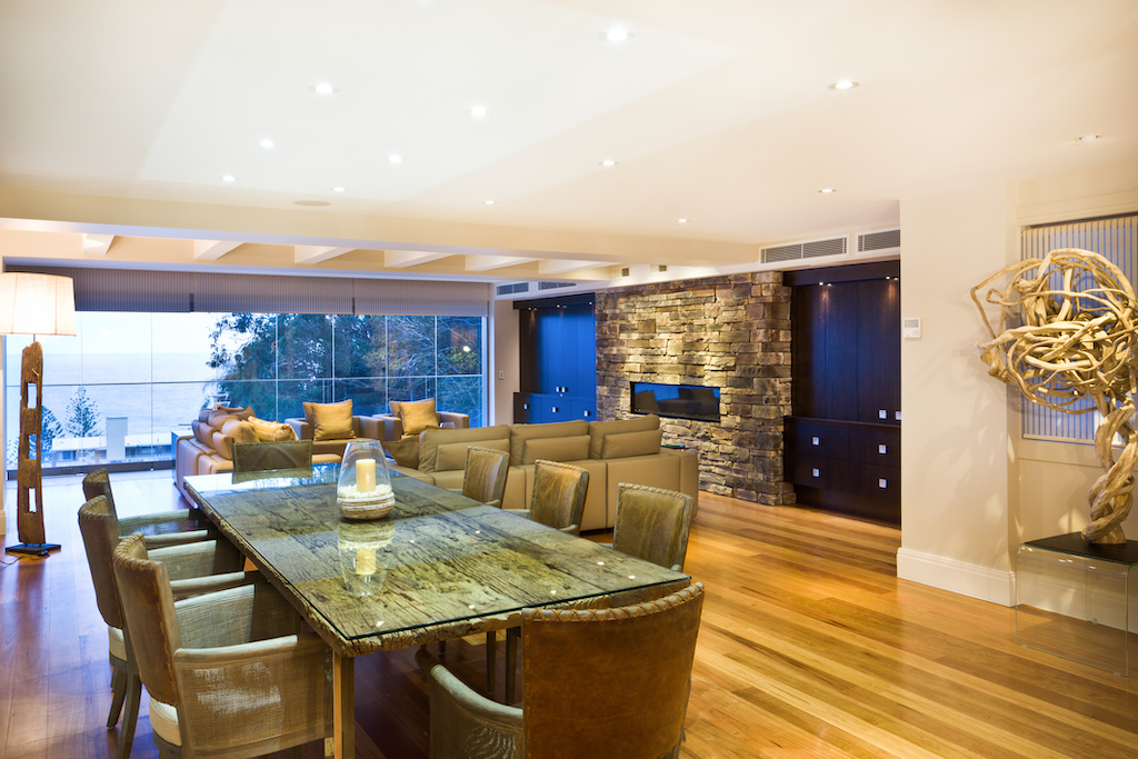 A living and dining room lit up with lights, thanks to a great electrician. 