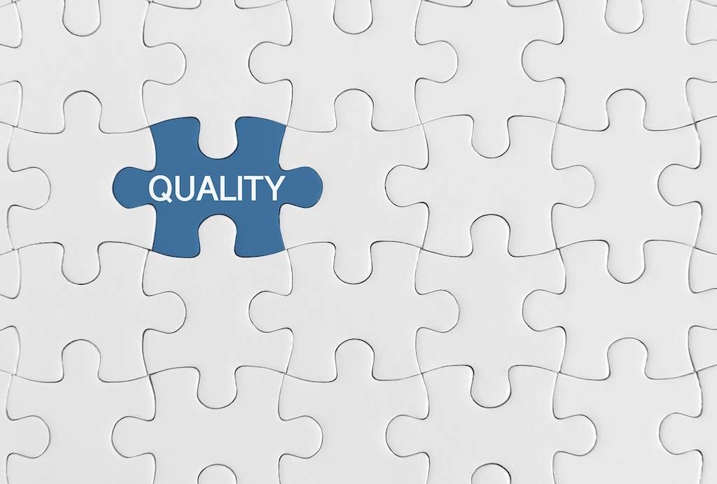 White puzzle pieces with a blue piece and the word 'quality'. Smoke detectors.