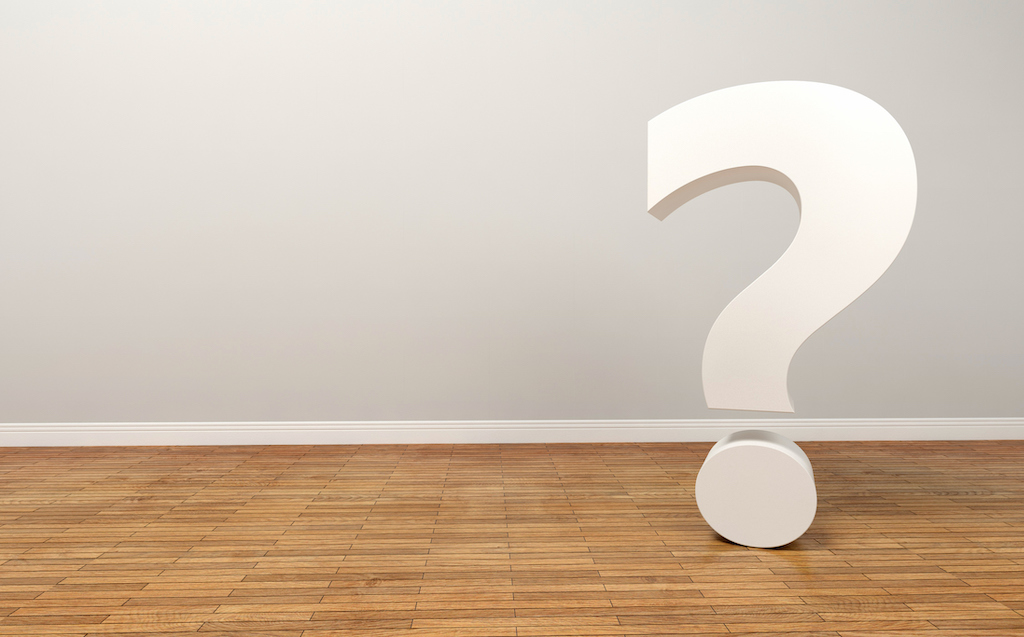 Large white question mark with wood floor representing questions about emergency electrical services.