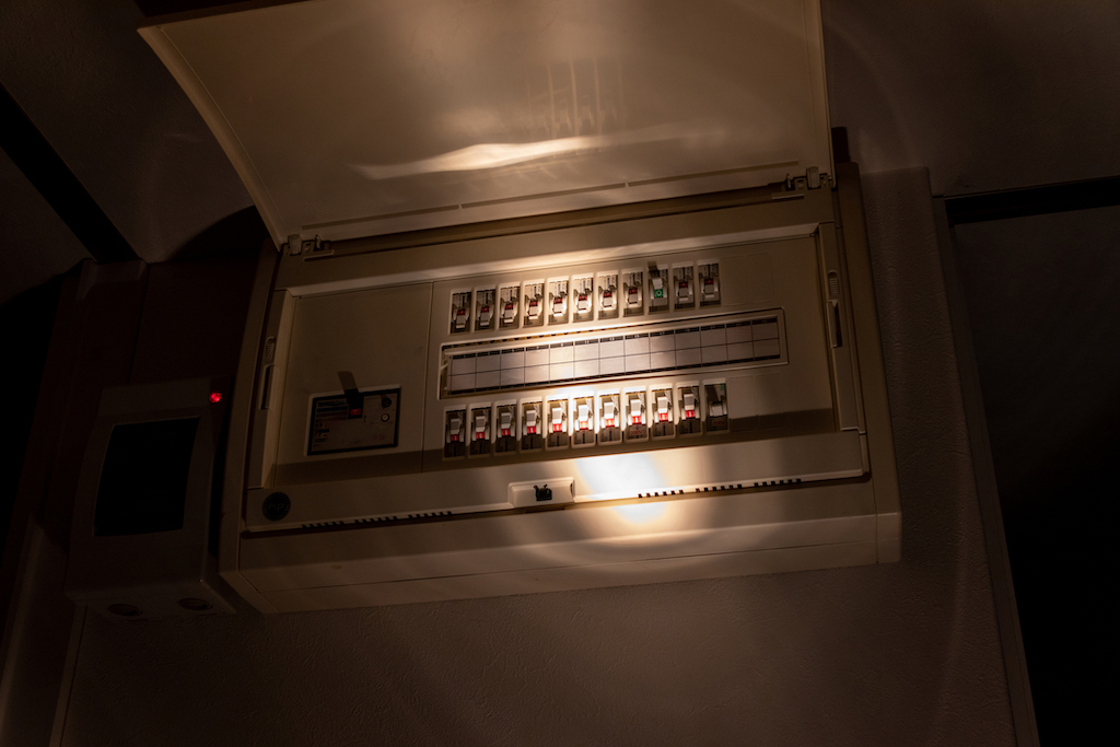 Switchboard with flashlight shining | Electrician
