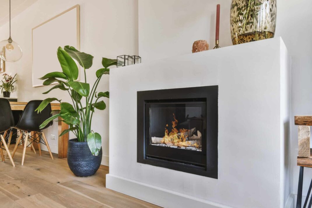 Modern electric fireplace in white wall.