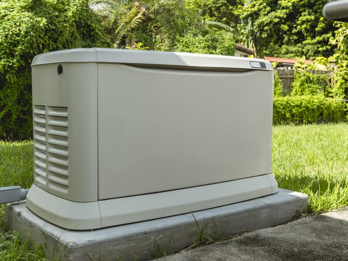 A Home Backup Generator installed at the backyard of a house.