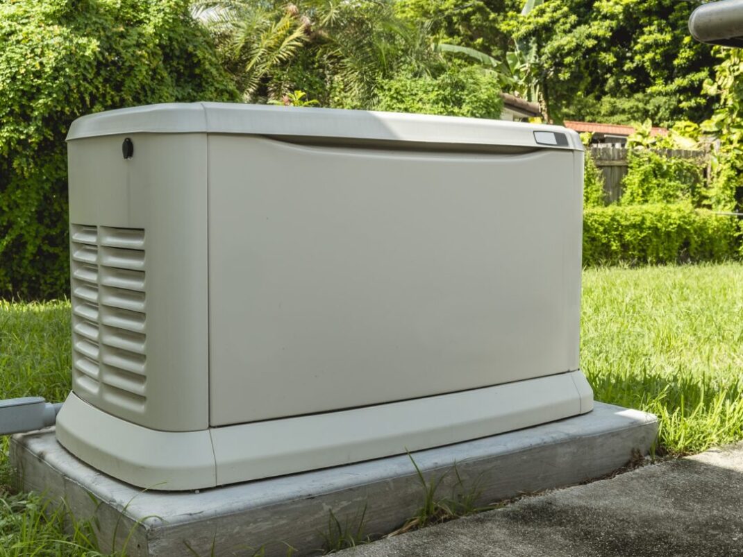 A Home Backup Generator installed at the backyard of a house.