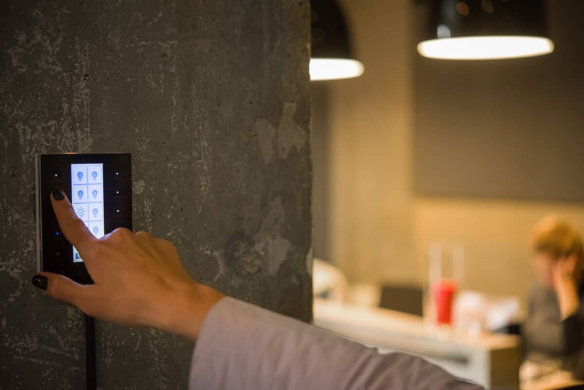 Girl adjusts the Smart Lighting Controls in the room.