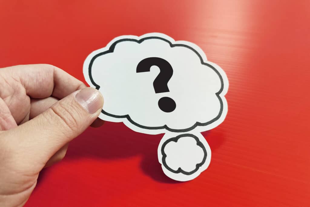 FAQ on electric furnace control failures represented by a hand holding a speech bubble with a question mark on red background.